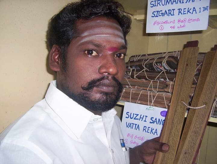 Nadi Astrologer Reading Palm Leaf